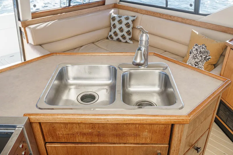 Slide: The Image of 1998 Bayliner 3988 Motoryacht kitchen with dual sinks and cozy seating area. - 31