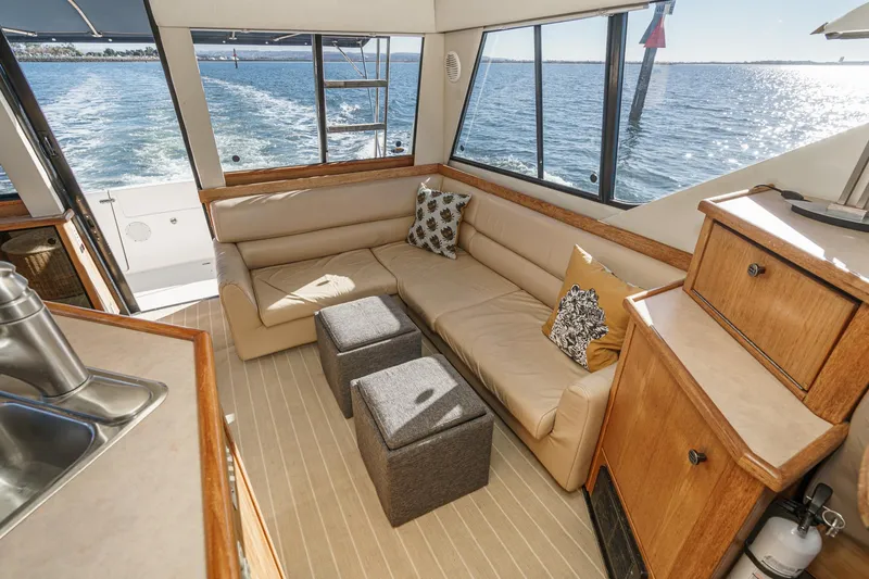 Slide: The Image of Luxurious interior of 1998 Bayliner 3988 Motoryacht with beige seating and ocean view. - 39