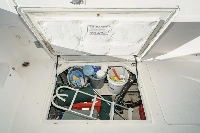 Slide: The Image of Storage compartment on a 1998 Bayliner 3988 Motoryacht with cleaning supplies and equipment. - 45