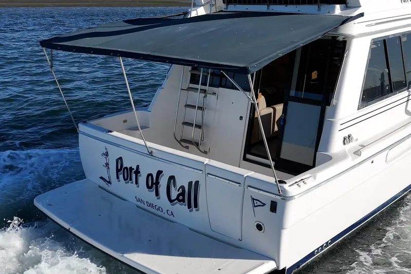 Slide: The Image of 1998 Bayliner 3988 Motoryacht cruising with "Port of Call" signage, San Diego, CA. - 49