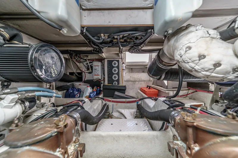 Slide: The Image of Engine room of 1998 Bayliner 3988 Motoryacht, showcasing mechanical components and wiring. - 6