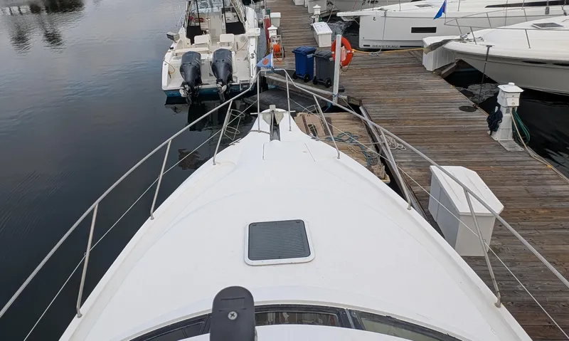 Slide: The Image of 1999 Silverton 351 Sedan Cruiser docked at marina, view from bow. - 10