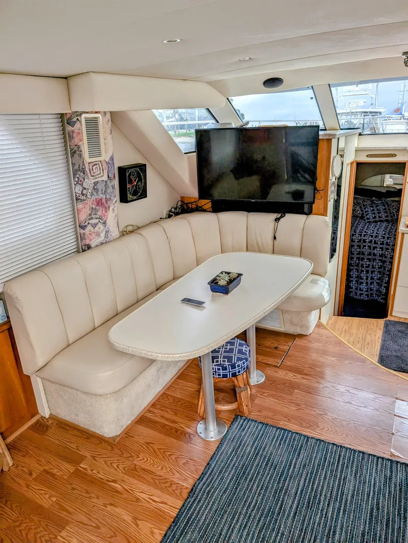 Slide: The Image of Interior of 1999 Silverton 351 Sedan Cruiser with dining area and TV. - 16