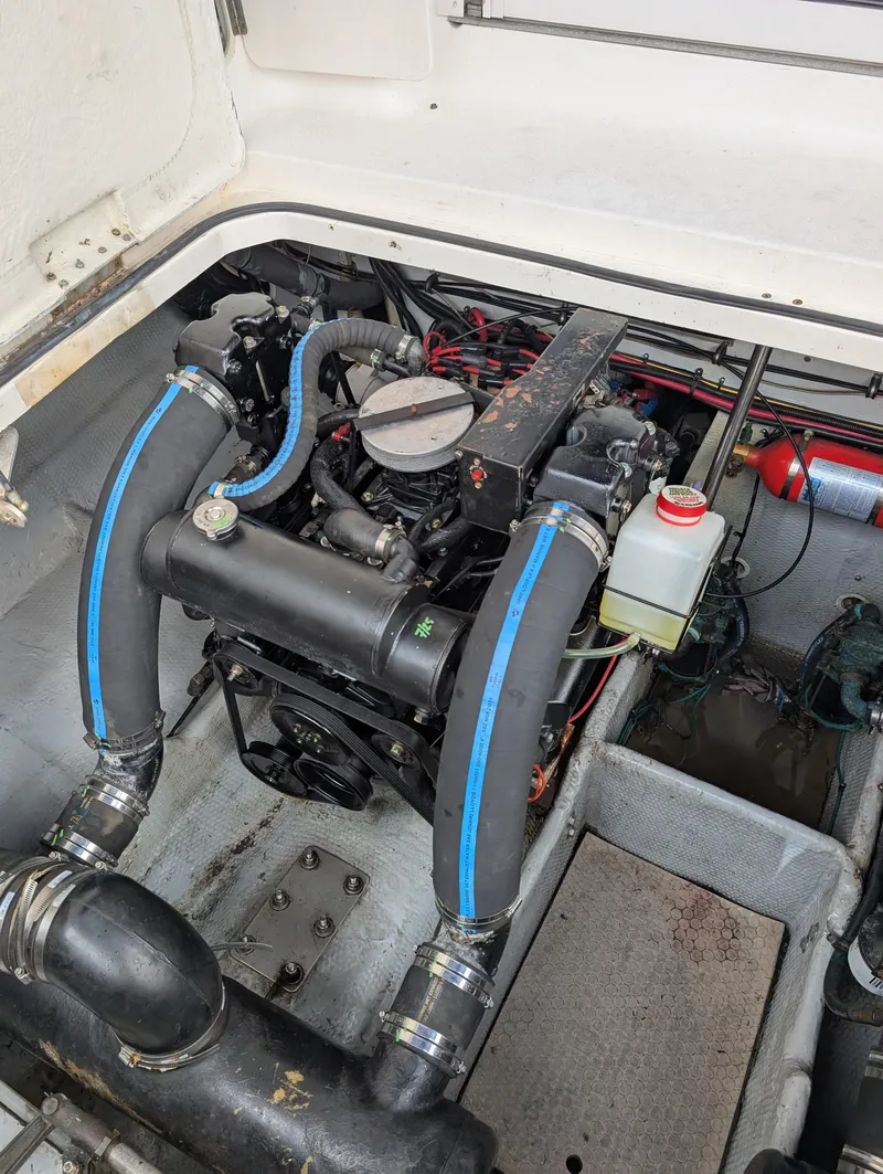 Slide: The Image of Engine compartment of a 1999 Silverton 351 Sedan Cruiser with visible hoses and components. - 17