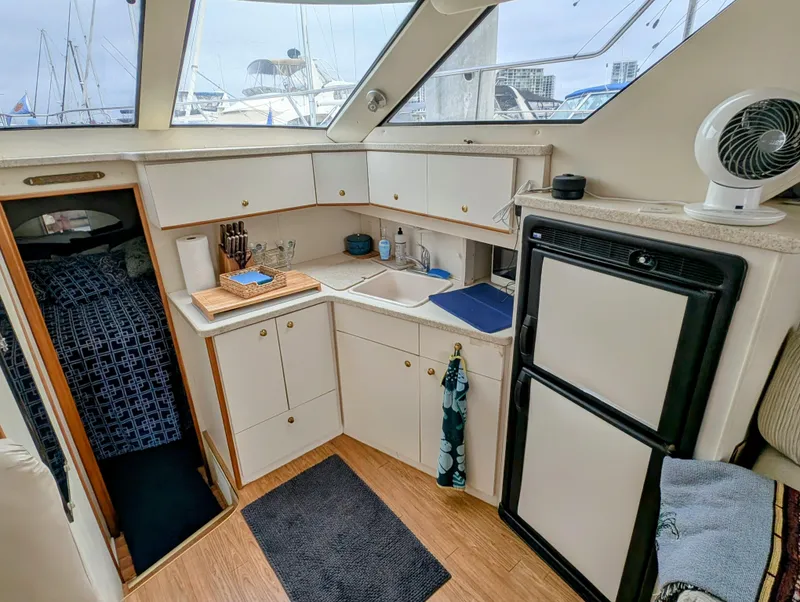 Slide: The Image of 1999 Silverton 351 Sedan Cruiser interior with kitchenette, sink, and refrigerator. - 2