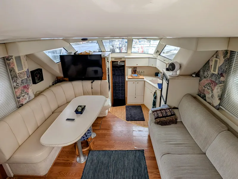 Slide: The Image of Interior of 1999 Silverton 351 Sedan Cruiser with seating, table, and kitchenette. - 3