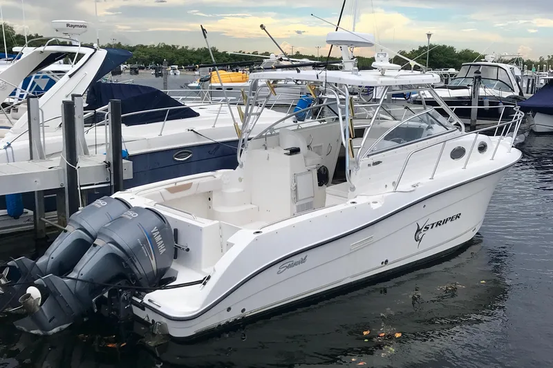 The Image of 2006 Seaswirl Striper 2901 Walkaround O/B boat docked with twin Yamaha engines. - 0