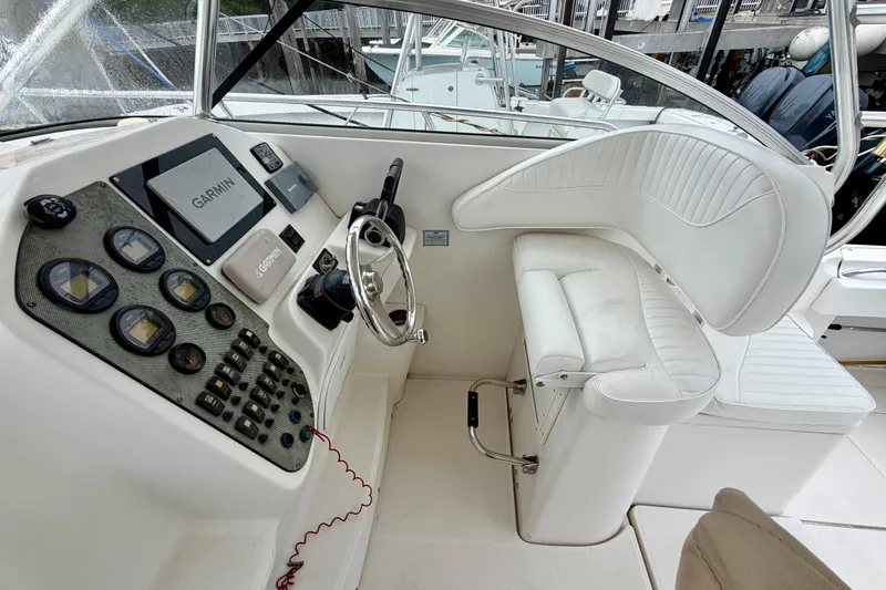 Slide: The Image of 2006 Seaswirl Striper 2901 Walkaround O/B helm with Garmin navigation and white seating. - 1