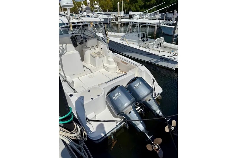 Slide: The Image of 2006 Seaswirl Striper 2901 Walkaround O/B with dual outboard engines docked at marina. - 13