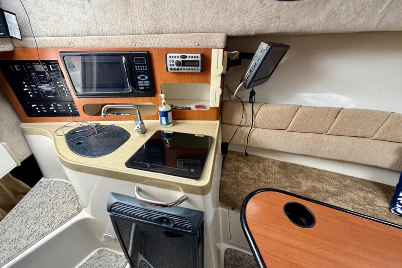 Slide: The Image of 2006 Seaswirl Striper 2901 Walkaround O/B cabin interior with kitchenette and seating area. - 14