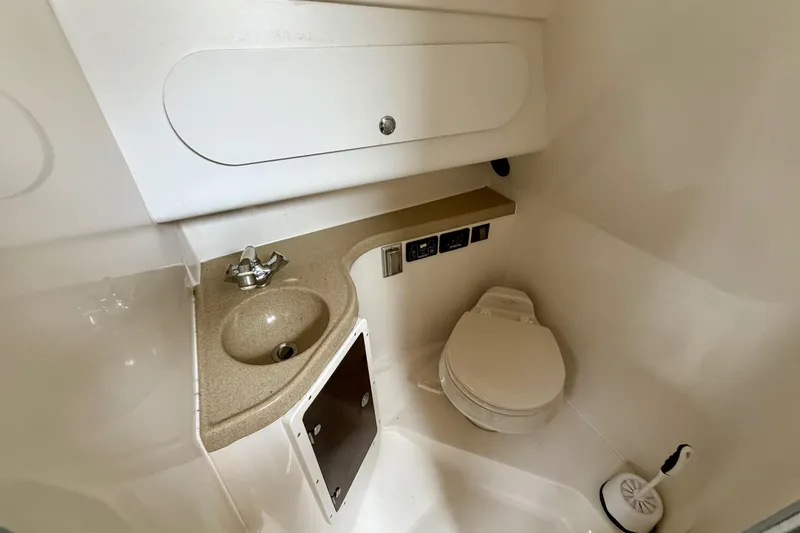 Slide: The Image of 2006 Seaswirl Striper 2901 Walkaround O/B boat bathroom with sink and toilet. - 17