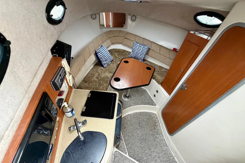 Slide: The Image of 2006 Seaswirl Striper 2901 Walkaround O/B cabin interior with kitchenette and seating area. - 2