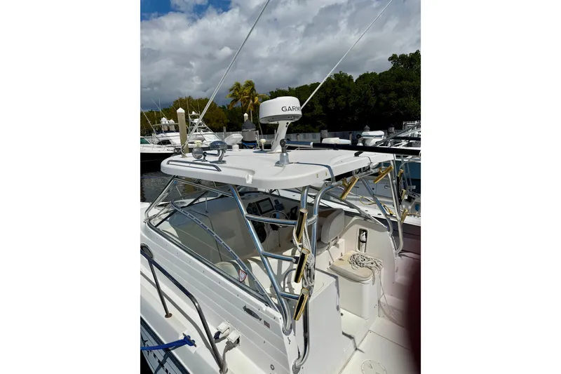 Slide: The Image of 2006 Seaswirl Striper 2901 Walkaround O/B boat with Garmin radar, docked under cloudy sky. - 6