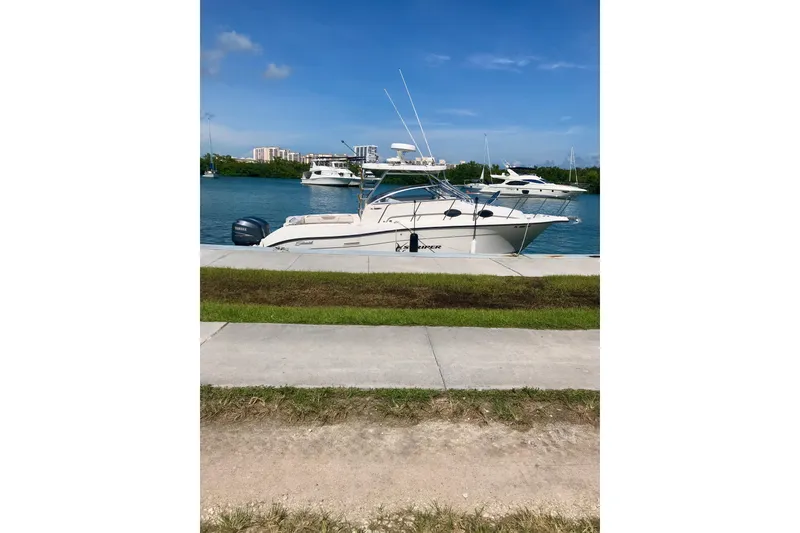 Slide: The Image of 2006 Seaswirl Striper 2901 Walkaround O/B docked by the waterfront on a sunny day. - 9