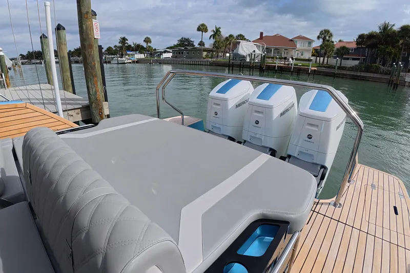 Slide: The Image of 2025 Schaefer V44 yacht with triple Mercury outboard engines docked by the water. - 10