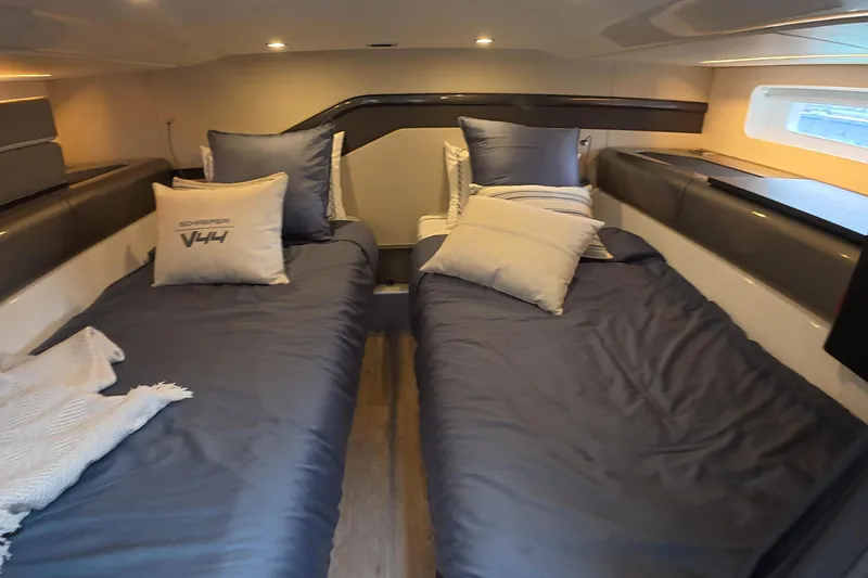Slide: The Image of Luxurious cabin interior of 2025 Schaefer V44 yacht with twin beds and modern decor. - 14