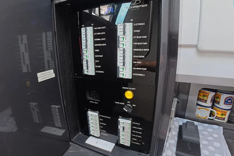 Slide: The Image of Electrical control panel on a 2025 Schaefer V44 yacht, featuring labeled switches and controls. - 18