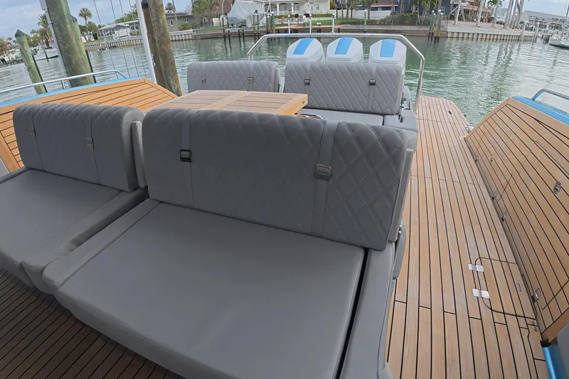 Slide: The Image of Luxury Schaefer V44 yacht deck with plush seating, 2025 model, docked by the water. - 20