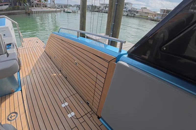 Slide: The Image of 2025 Schaefer V44 yacht deck with sleek wood finish and modern design. - 25