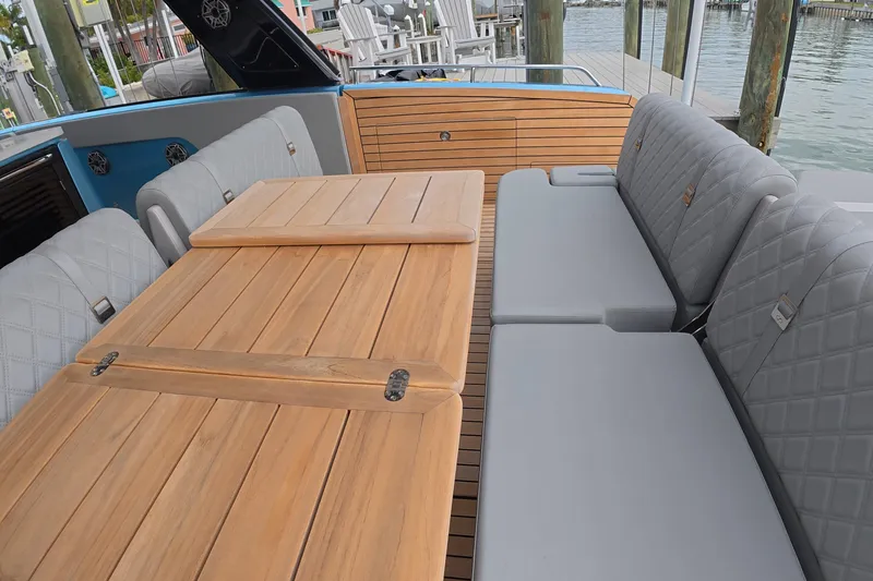 Slide: The Image of Luxurious seating area on 2025 Schaefer V44 yacht with wooden table and cushioned benches. - 28