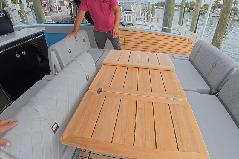 Slide: The Image of 2025 Schaefer V44 yacht interior with wooden table and cushioned seating. - 31