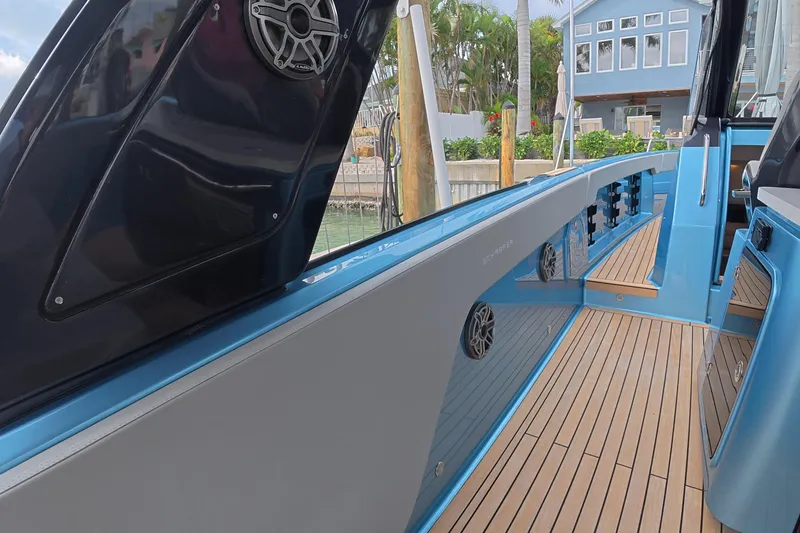 Slide: The Image of 2025 Schaefer V44 yacht with sleek design, featuring teak decking and modern audio system. - 34