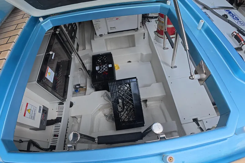 Slide: The Image of Engine compartment of 2025 Schaefer V44 boat with equipment and storage crates. - 35