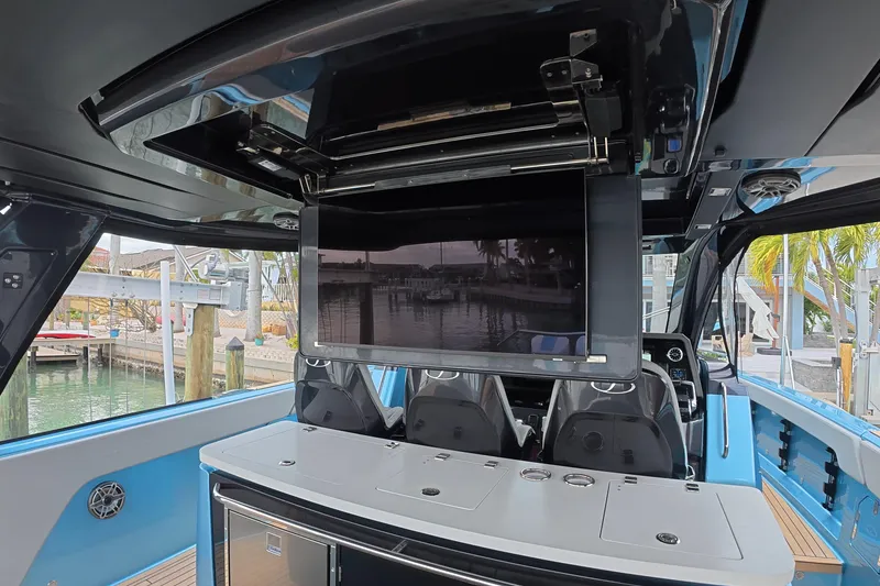 Slide: The Image of Interior of 2025 Schaefer V44 yacht with modern entertainment system and seating. - 38