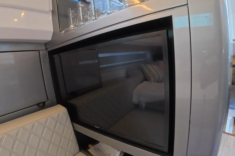Slide: The Image of Interior of 2025 Schaefer V44 yacht with modern TV and seating area. - 46
