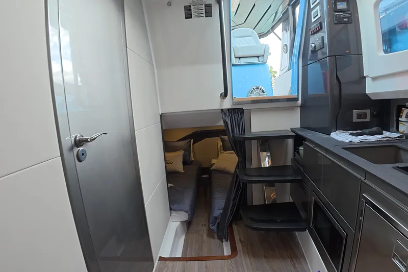 Slide: The Image of Interior of 2025 Schaefer V44 yacht featuring modern kitchen and cozy sleeping area. - 48