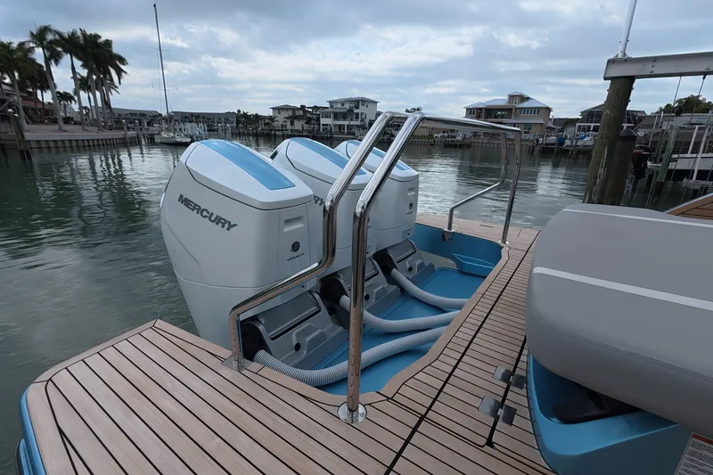 Slide: The Image of 2025 Schaefer V44 yacht with dual Mercury outboard engines docked by waterfront homes. - 9