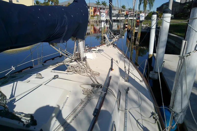 Slide: The Image of 1988 Pearson 36-2 sailboat docked, featuring rigging and covered mainsail. - 24