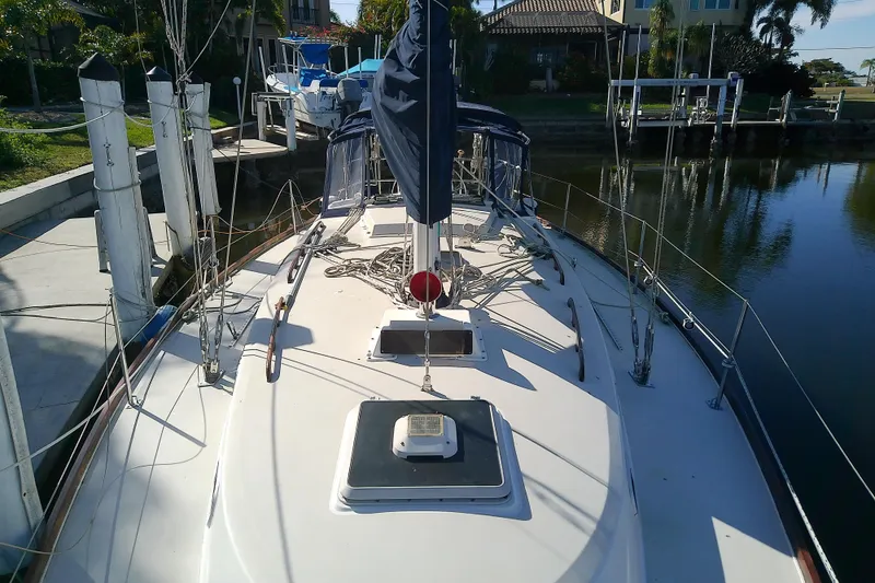 Slide: The Image of 1988 Pearson 36-2 sailboat docked in a serene marina setting. - 27