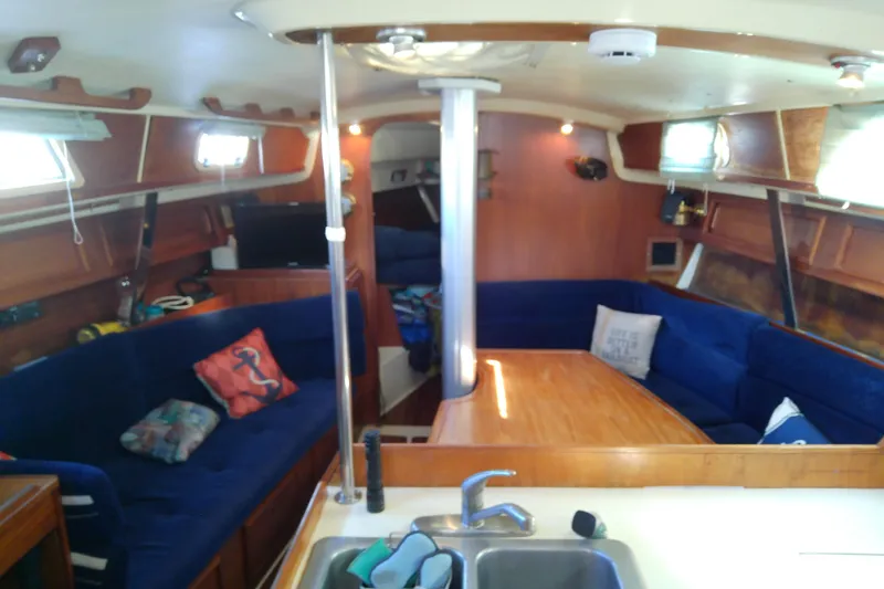 Slide: The Image of Interior of 1988 Pearson 36-2 sailboat with cozy seating and wooden table. - 29