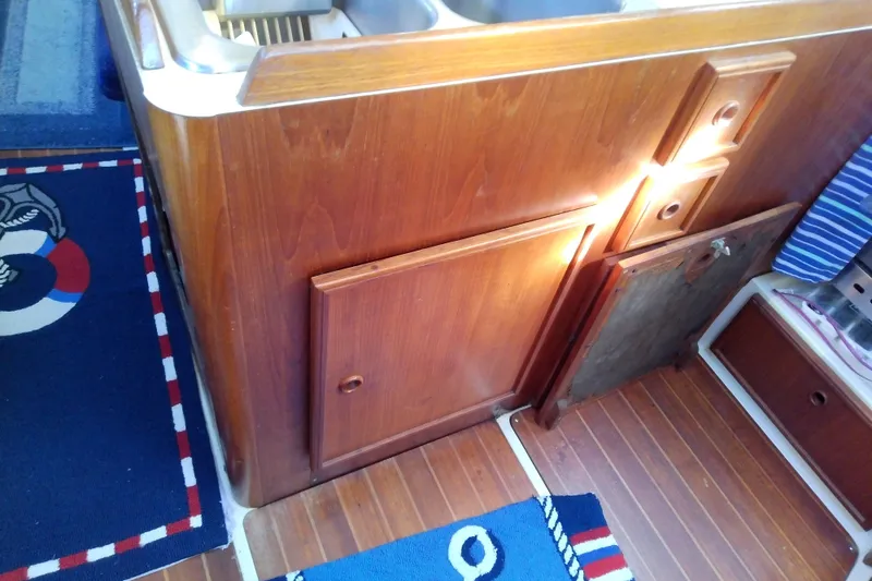 Slide: The Image of 1988 Pearson 36-2 yacht interior with wooden cabinetry and nautical-themed decor. - 33