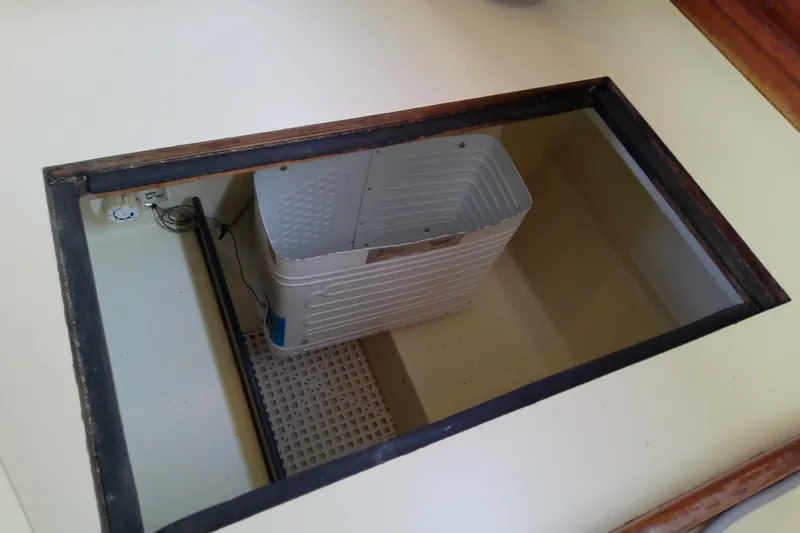 Slide: The Image of Open compartment in 1988 Pearson 36-2 boat, featuring a storage bin. - 34