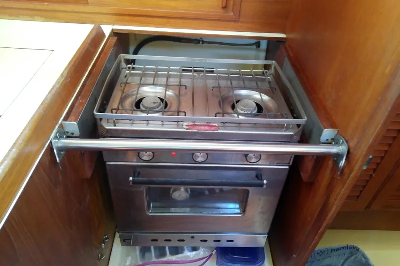Slide: The Image of Stainless steel stove in 1988 Pearson 36-2 yacht kitchen with wooden cabinetry. - 38