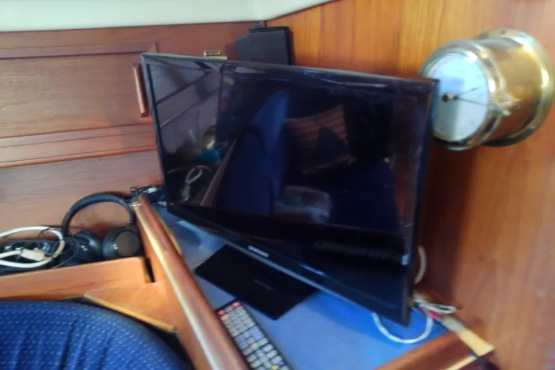 Slide: The Image of Interior of 1988 Pearson 36-2 yacht with TV, headphones, and nautical decor. - 42