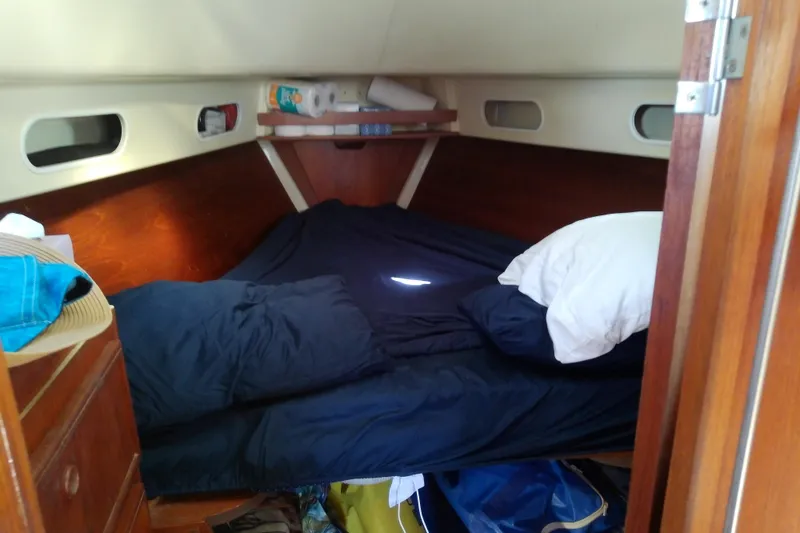 Slide: The Image of Cozy cabin interior of a 1988 Pearson 36-2 sailboat with a neatly made bed. - 43