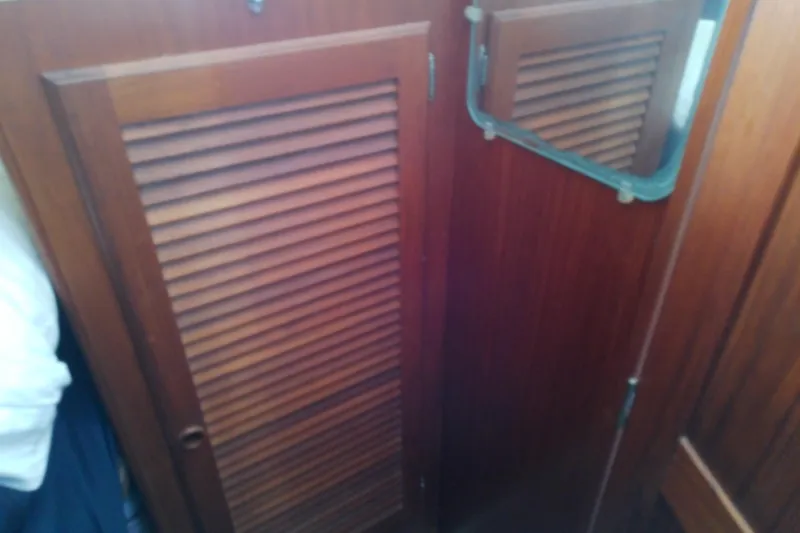 Slide: The Image of Wooden interior of 1988 Pearson 36-2 sailboat with louvered door and mirror. - 45