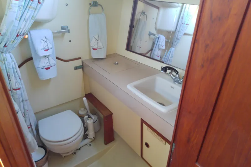 Slide: The Image of 1988 Pearson 36-2 yacht bathroom with sink, toilet, and nautical-themed decor. - 48