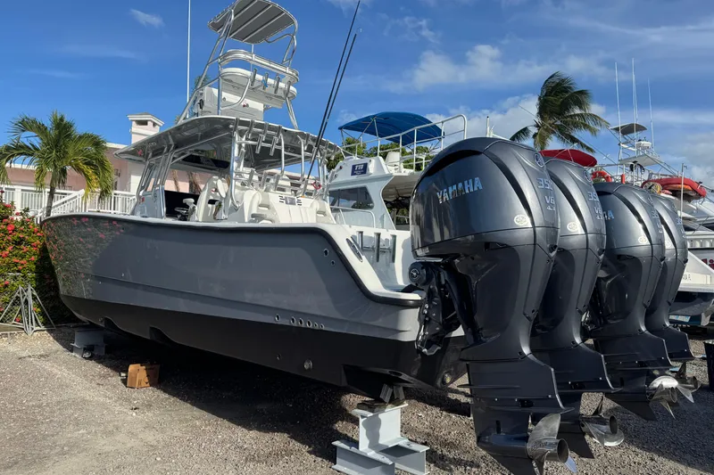 Slide: The Image of 2024 Freeman 42 boat with Yamaha engines, docked under clear blue sky. - 5