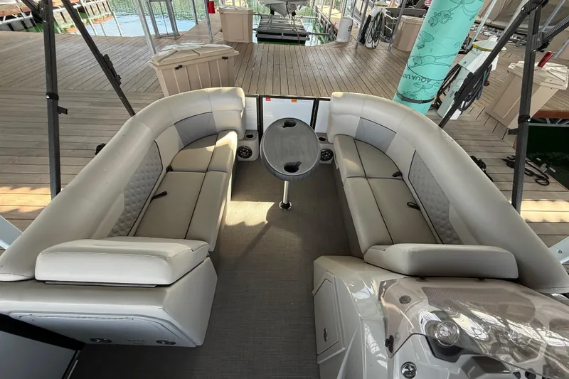Slide: The Image of Interior of 2022 Crest Classic DLX 220 SLS pontoon boat with plush seating and table. - 10