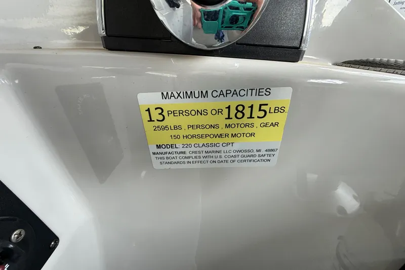 Slide: The Image of 2022 Crest Classic DLX 220 SLS capacity label, 13 persons or 1815 lbs, 150 horsepower motor. - 12