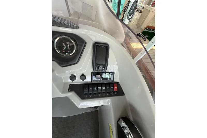 Slide: The Image of 2022 Crest Classic DLX 220 SLS dashboard with gauges and control panel. - 13