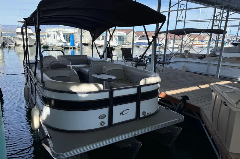 Slide: The Image of 2022 Crest Classic DLX 220 SLS pontoon boat docked at marina. - 4