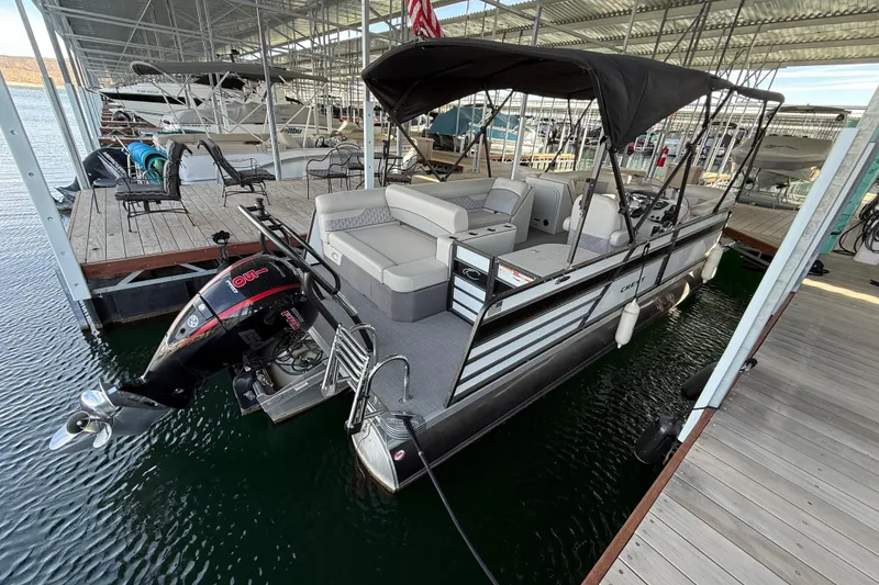 Slide: The Image of 2022 Crest Classic DLX 220 SLS pontoon boat docked in marina. - 5