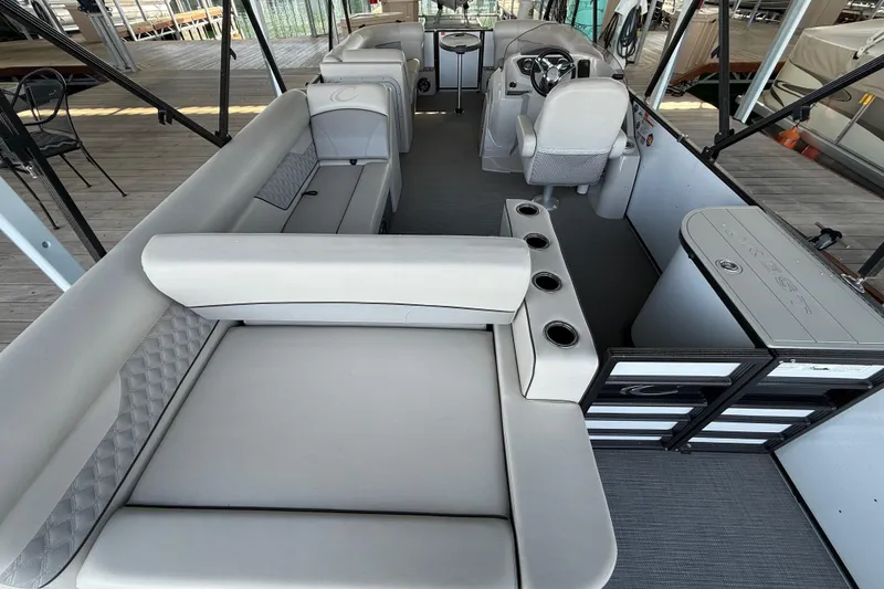 Slide: The Image of 2022 Crest Classic DLX 220 SLS pontoon boat interior with spacious seating and modern design. - 6