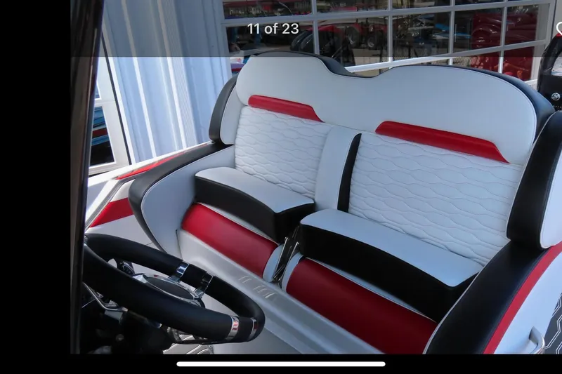 Slide: The Image of 2022 Sunsation 32 CCX boat interior with stylish seating and modern dashboard. - 10