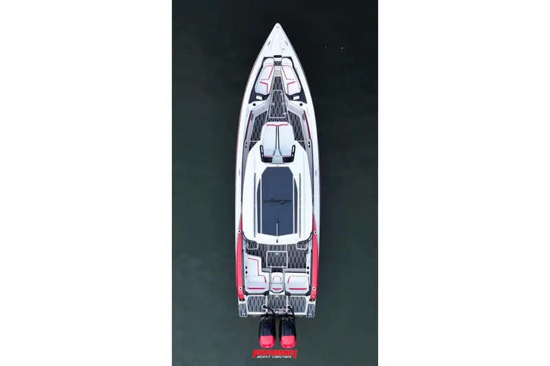 Slide: The Image of 2022 Sunsation 32 CCX boat with sleek white and red seating, docked outdoors. - 14